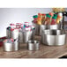 An American Metalcraft stainless steel double wall bowl filled with a liquid container on a table.