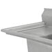 A close-up of an Advance Tabco three compartment pot sink with a left drainboard.