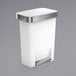 A white simplehuman rectangular front step-on trash can with a silver lid.