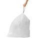 A person holding a white simplehuman Code G trash can liner.
