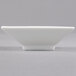 A CAC Citysquare white square bowl on a gray surface.