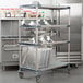 A Metro Metromax iQ metal drying rack with trays on it.