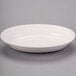 An ivory oval china platter with an embossed rim.