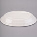 An ivory oval china platter with an embossed rim.