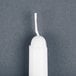 A white Will & Baumer taper candle with a white string.