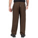 A person wearing Uncommon Chef black and brown striped pants.
