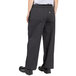 A person wearing gray pinstripe chef pants.