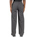 The legs of a person wearing Uncommon Chef grey pants.