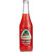 A close up of a Jarritos Fruit Punch Soda bottle with a red label.
