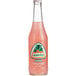 A close up of a Jarritos Guava Soda bottle filled with pink liquid.