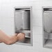 a person washing hands in a hand sanitizer dispenser