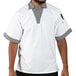 A man wearing a white Uncommon Chef cook shirt with Shepherd's check trim.