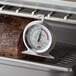 A Cooper-Atkins hot holding thermometer in a roaster.