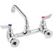 A chrome Waterloo wall-mounted faucet with red and blue knobs.