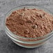 A bowl of Ghirardelli Ultimate Chocolate Cake mix powder with chocolate chips.