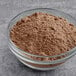 A bowl of Krusteaz Devil's Food Cake Mix, a brown powder.