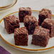 A plate of Krusteaz fudge brownies on a white surface.