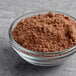 A bowl of brown Krusteaz Professional Fudge Brownie Mix powder.