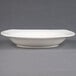 A CAC ivory square pasta bowl with a small rim on a white surface.