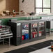 An Avantco back bar refrigerator with sliding glass doors filled with bottles of beer.