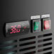 The digital display on an Avantco back bar cooler with red numbers.