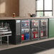 An Avantco back bar refrigerator with drinks and beverages inside.