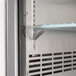 The narrow solid door of an Avantco back bar refrigerator.