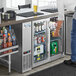 A man putting a beverage into an Avantco narrow glass door back bar refrigerator.