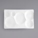 A close-up of a white rectangular porcelain platter with six compartments.