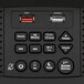 A close up of a black Conair Bluetooth digital alarm clock with USB ports.