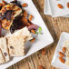A close-up of a plate of food with crackers and cheese on a white Front of the House Mod square porcelain plate.