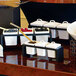 A white square porcelain pot with a notched lid on a hotel buffet counter.