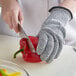 a person cutting a red pepper
