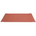 A red Cactus Mat rubber floor mat with holes in it.