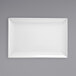 A white rectangular Front of the House porcelain plate on a gray surface.