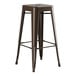 A brown metal Lancaster Table & Seating outdoor backless barstool with a wooden seat.