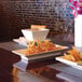 A Front of the House Kyoto rectangular porcelain footed plate with fried food on a table.