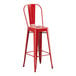 A red Lancaster Table & Seating metal outdoor cafe barstool with a seat and back.