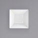 A white square bowl with a grey background.