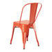 A Lancaster Table & Seating orange metal outdoor cafe chair.