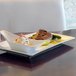 A white rectangular porcelain plate with food on it.