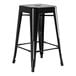 A Lancaster Table & Seating black metal backless counter height stool with legs and a seat.