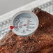 An AvaTemp meat thermometer with a 5" probe in a piece of meat.