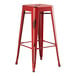 A Lancaster Table & Seating red metal backless barstool with legs.