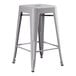 A Lancaster Table & Seating gray metal backless counter height stool.