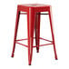 A red metal Lancaster Table & Seating backless counter height stool with legs.