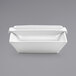 A white rectangular porcelain ramekin with a handle.