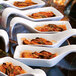 Front of the House Kyoto white porcelain tasting spoons filled with food on a table.