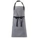 A grey apron with black straps and a black belt.