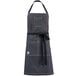 A gray Mercer Culinary bib apron with black straps.